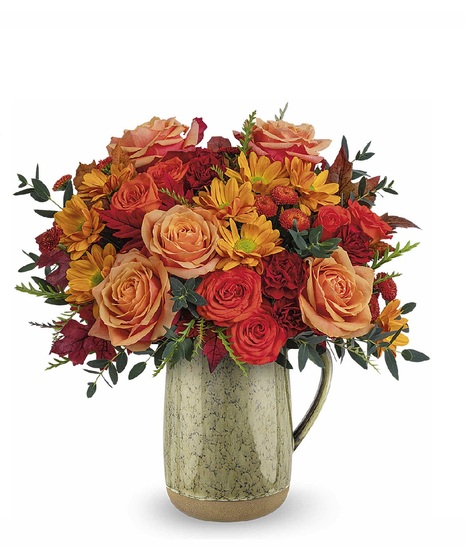 fall toned flowers in ceramic vase