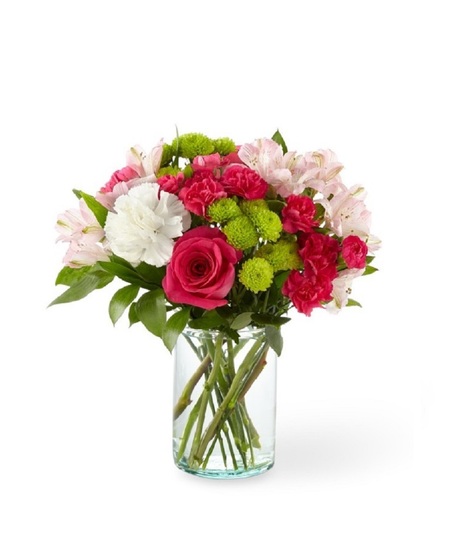 Bright pink roses, pink alstroemeria, white carnations and green mums in a clear glass vase