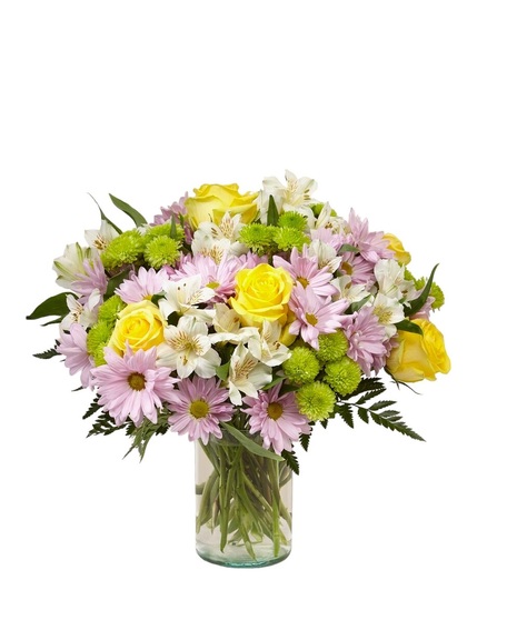 Bright pink roses, pink alstroemeria, white carnations and green mums in a clear glass vase
