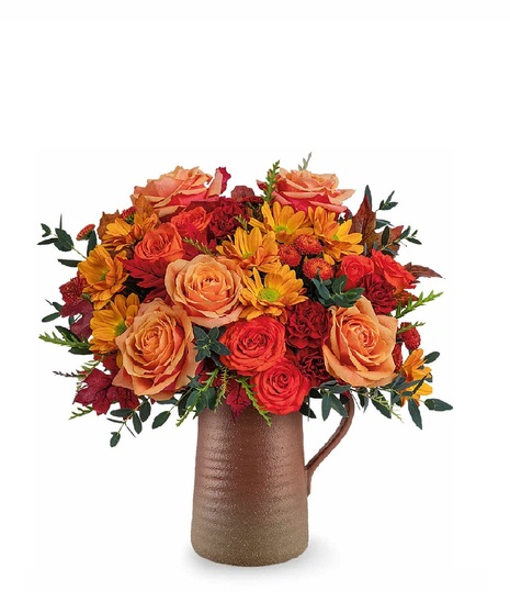 fall toned flowers in ceramic vase