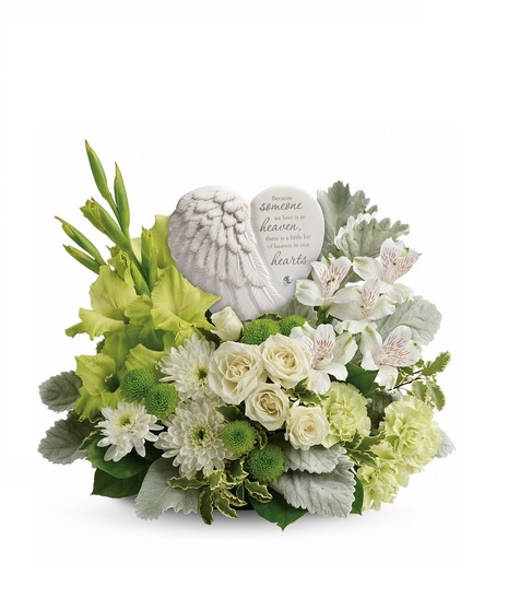 Funeral arrangement of white flowers and greenery in an elegant basket.