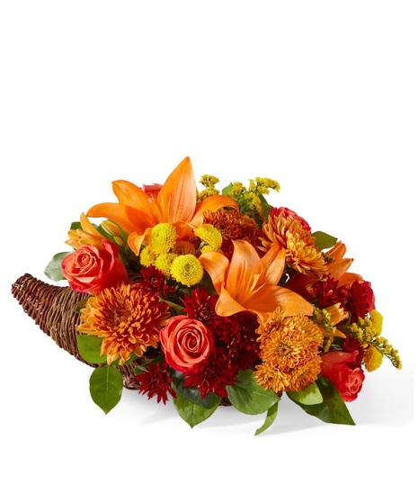 fall toned flowers in cornucopia container