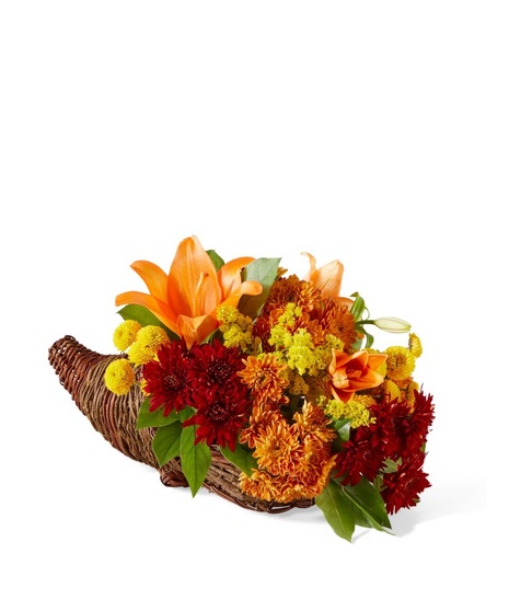 fall toned flowers in cornucopia container